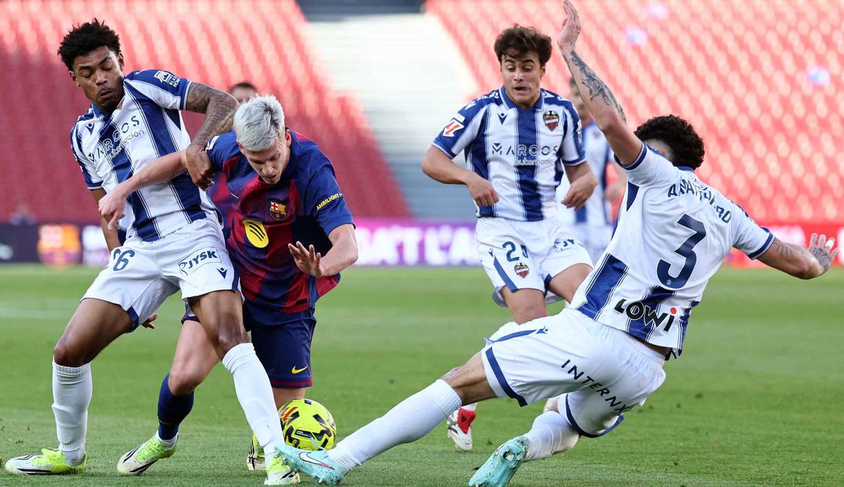 Bertanding di Stadion Camp Nou, Barcelona sukses membungkam Levante dengan skor telak 3-0. Tampak dalam foto, gelandang Barcelona asal Spanyol, Daniel Olmo (kedua kiri) berusaha melewati adangan tiga pemain Levante, Kareem Tunde (kiri), Matias Agustin Moreno, dan Alan Matturro (kanan) selama pertandingan pekan ke-25 La Liga 2025/2026 di Stadion Camp Nou, Minggu 22 Februari 2026. (Josep LAGO/AFP)