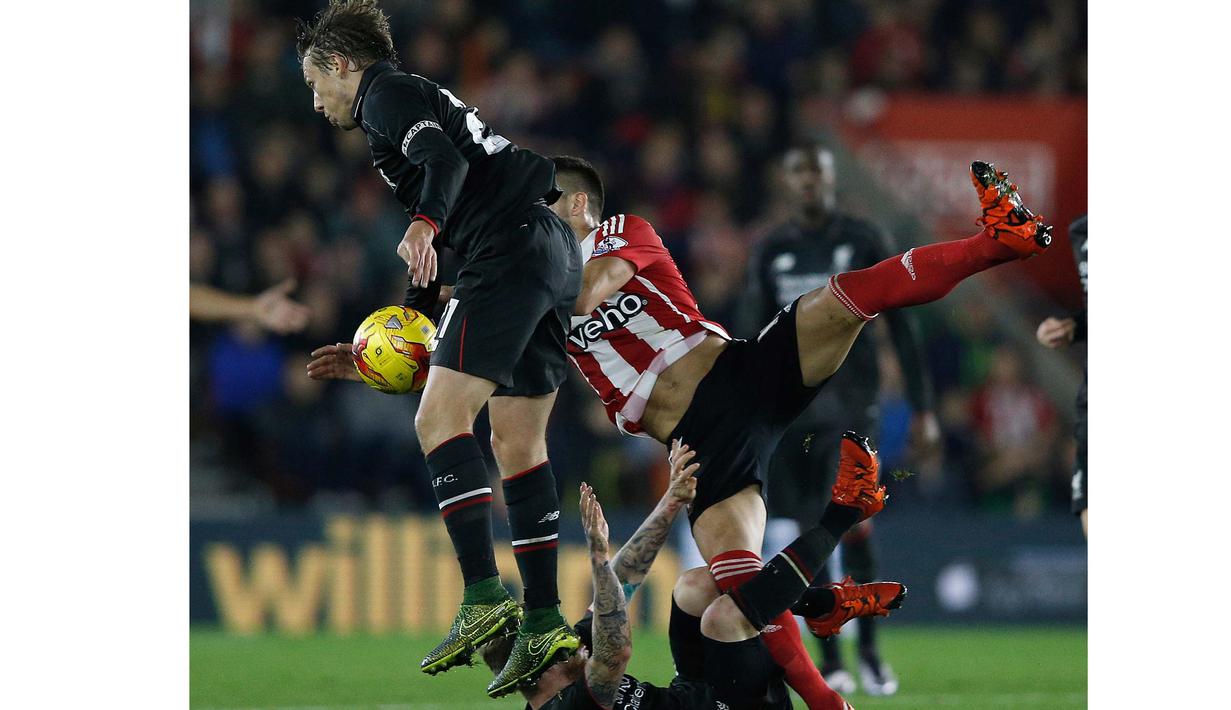 Pemain Liverpool, Lucas Leiva (kiri) berduel dengan pemain Southampton,  Dusan Tadic (kanan) pada laga Piala Liga Inggris di Stadion St. Mary's; Southampton; Kamis (3/12/2015) dini hari WIB. (AFP Photo/Adrian Dennis)