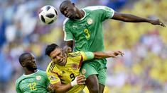 Pemain Kolombia, Radamel Falcao (tengah) berusaha menyundul bola dari kawalan dua pemain Senegal pada laga terakhir grup H di Samara Arena, Samara, Rusia, (28/6/2018). Kolombia menang 1-0. (AP/Martin Meissner)