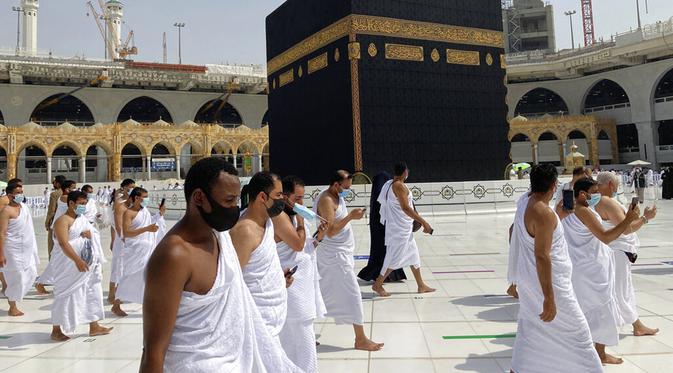 Umat muslim mengelilingi Kakbah mengenakan masker dan menjaga jarak untuk membantu menghentikan penyebaran virus corona COVID-19 saat pelaksanaan umrah di Masjidil Haram, Makkah, Arab Saudi, Minggu (30/5/2021). (AP Photo/Amr Nabil)