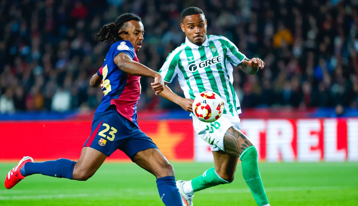 Pemain Barcelona, Jules Kounde, mencetak gol ke gawang Real Betis pada laga babak 16 besar Copa del Rey 2024/2025 yang dihelat di Estadi Olimpic Lluis Companys, Kamis (16/1/2025) dini hari WIB. (AFP/Manaure Quintero)