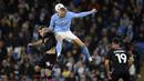 Pemain Manchester City, Erling Haaland (tengah) berebut bola dengan pemain Burnley, Josh Cullen pada laga perempat final FA Cup 2022/2023 yang berlangsung di Etihad Stadium, Manchester, Minggu (19/03/2023) WIB. Haaland sukses mencetak hattrick untuk kemenangan 6-0 The Cityzens. (AFP/Oli Scarff)