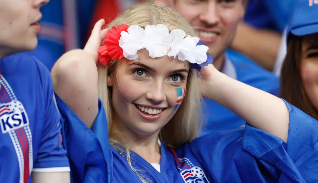 Seorang suporter timnas Islandia tersenyum mengunakan atribut di kepalanya saat menghadiri pertandingan antara Islandia melawan timnas Perancis dalam Perempat Final Piala Eropa 2016 di Stade de France, Prancis, (3/7).  (Reuters/Carl Recine)
