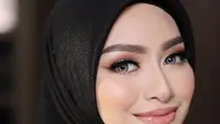 Nathalie tampil dengan kerudung warna hitam yang membuatnya tampil lebih glamor. Ditambah dengan riasan mata eyedshadow shimmer dan cokelatnya, serta lipstik pink serasi dengan blushonnya. Credit: Instagram (@nathalieholscher)