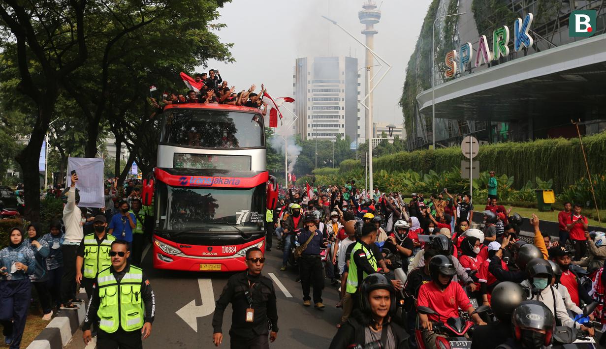Bus yang ditumpangi Timnas Indonesia U-22 melewati pusat perbelanjaan Senayan Park saat pawai kontingen Indonesia untuk SEA Games 2023 yang bertajuk Kira87uara yang berlangsung di Jakarta, Jumat (19/05/2023). (Bola.com/Bagaskara Lazuardi)