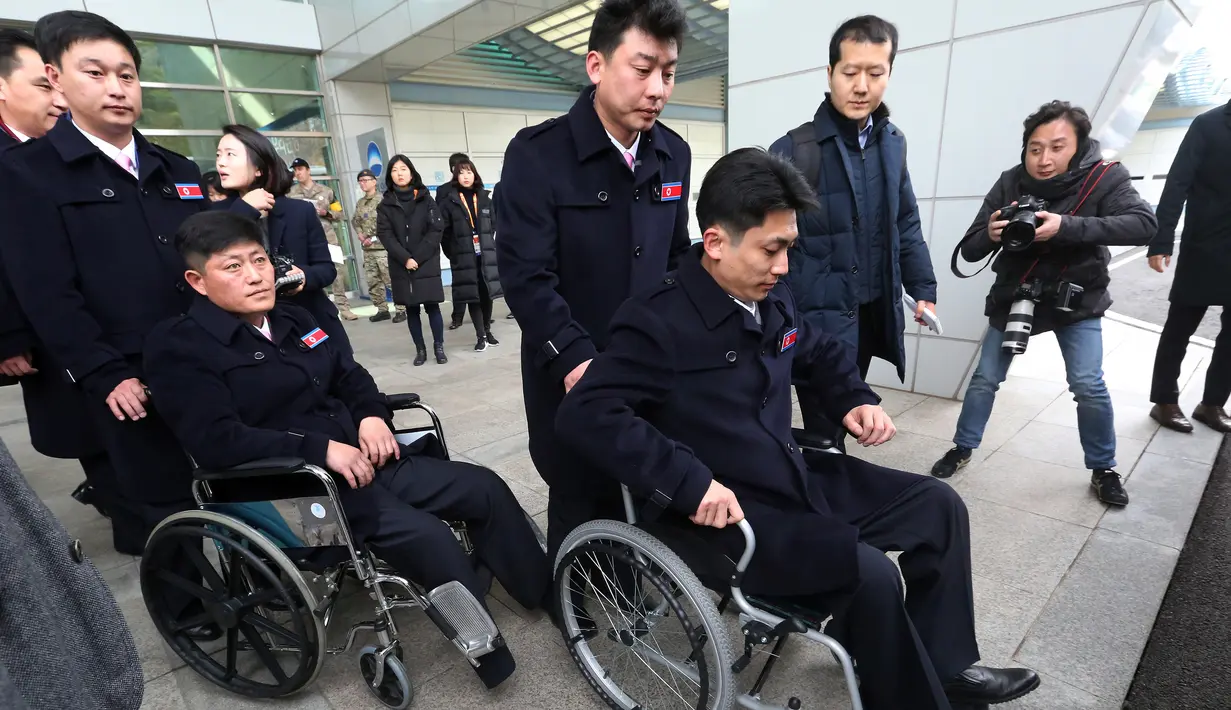 Atlet Paralimpiade Pyeongchang 2018 asal Korea Utara bersiap menaiki bus setibanya di Paju, Korea Selatan, Rabu (7/3). Kontingen atlet Korea Utara mengikuti pertandingan ski cross-country pada 11 dan 14 Maret mendatang. (Ahn Young-joon/POOL/AFP)
