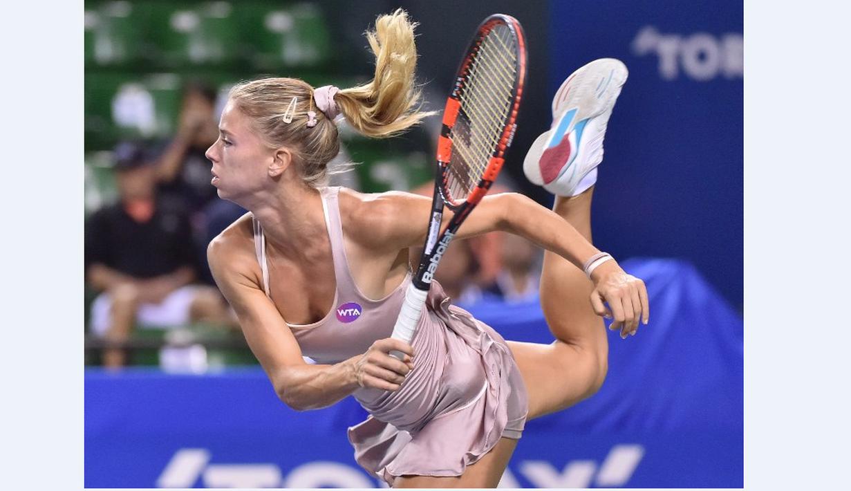 Petenis putri Italia, Camila Giorgi, saat melakukan servis ke arah petenis Serbia, Ana Ivanovic, dalam turnamen tenis Pan Pacific Terbuka di Tokyo, Jepang, Kamis (24/9/2015). (AFP Photo/Kazuhiro Nogi)