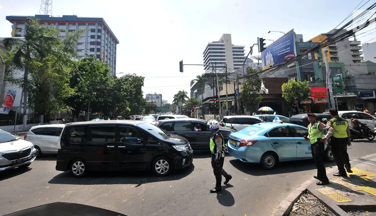 Polisi mengatur kemacetan lalu lintas saat uji coba sistem satu arah (SSA) di Jalan H Agus Salim dan Jalan KH Wahid Hasyim, Jakarta, Selasa (9/10). Uji coba ini berlangsung setiap pukul 09.00 WIB hingga 20.00 WIB. (Merdeka.com/Iqbal Nugroho)