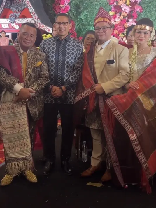 Sandiaga Salahuddin Uno Menteri Pariwisata dan Ekonomi Kreatif Republik Indonesia hadir mengenakan atasan batik lengan panjang dipadukan celana hitam bahan lengkap dengan sepatu pantofelnya.  [@fcgweddings]