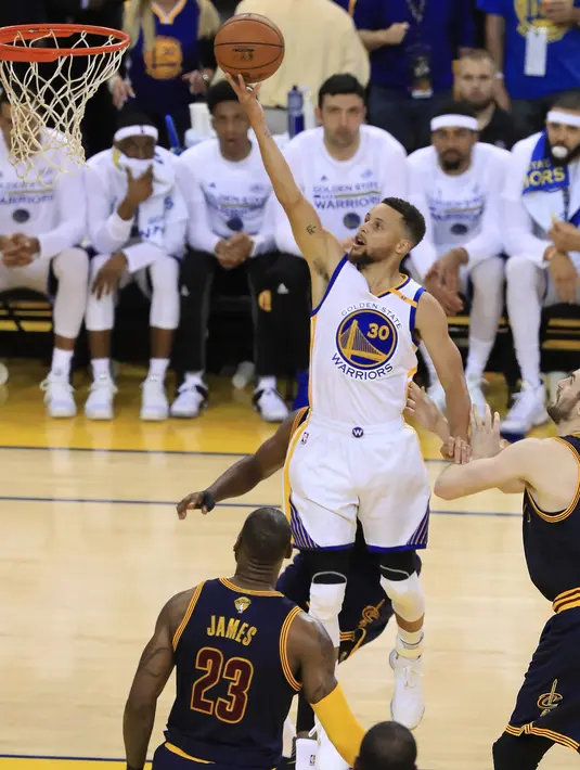 Stephen Curry (30) berusaha memasukan bola dari kawalan LeBron James (23) di gim pertama Final NBA 2017 di Oracle Arena di Oakland, California (1/6). Warriors  menang atas Cavaliers 113-91. (Ronald Martinez/Getty Images/AFP)