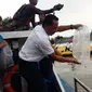 Melepas ikan meruwat Kali Surabaya (Liputan6.com/Dian Kurniawan)