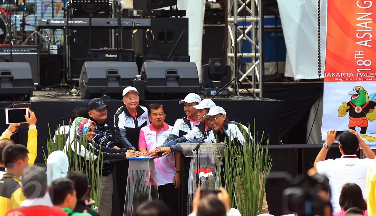 Wapres Jusuf Kalla, Menpora Imam Nahrawi, Gubernur Palembang Alex Noerdin berserta jajarannya saat menekan tombol peluncuran logo Asian Games 2018 Jakarta - Palembang, di Plaza Selatan, Senayan, Jakarta, Minggu (27/12/2015). (Liputan6.com/Johan Tallo)