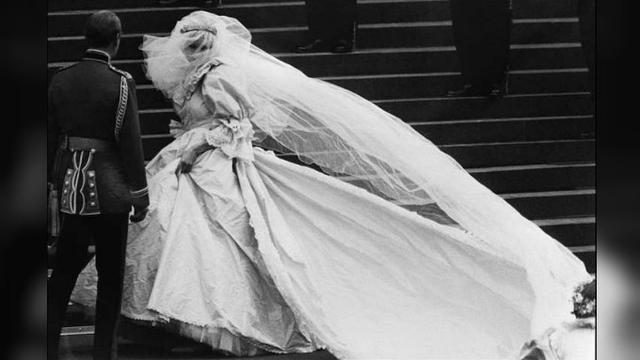 Putri Diana tampak mengangkat gaun pernikahannya (AFP)