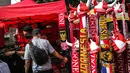 Suporter memilih atribut Timnas Indonesia jelang pertandingan AFF 2022 antara Indonesia melawan Thailand di Stadion Gelora Bung Karno, Jakarta, Kamis (29/12/2022). Atribut timnas Indonesia seperti kaos, syal, dan topi dijual dengan kisaran harga Rp35.000 hingga Rp75.000. (Liputan6.com/Faizal Fanani)
