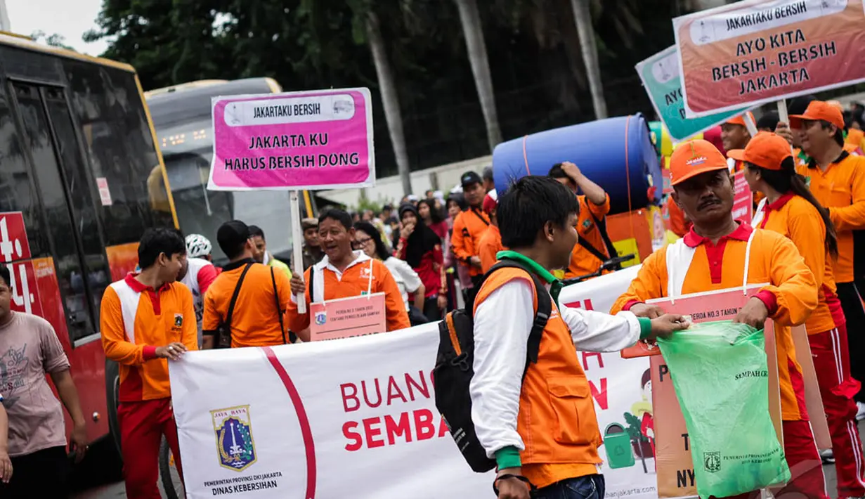 Aksi petugas Dinas Kebersihan Jakarta di Bundaran HI, Minggu (28/12/2014). (Liputan6.com/Faizal Fanani)