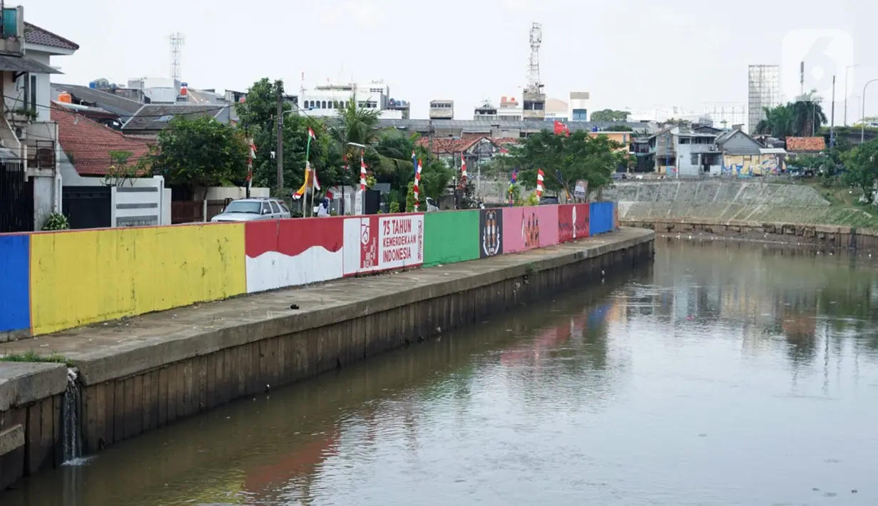 Mural bertema Kemerdekaan RI menghiasi dinding turap Sungai Ciliwung di kawasan Kampung Melayu, Jakarta, Minggu (16/8/2020). Mural karya petugas Pekerja Penanganan Sarana dan Prasarana Umum (PPSU) tersebut dibuat dalam rangka memeriahkan HUT ke-75 RI. (Liputan6.com/Immanuel Antonius)