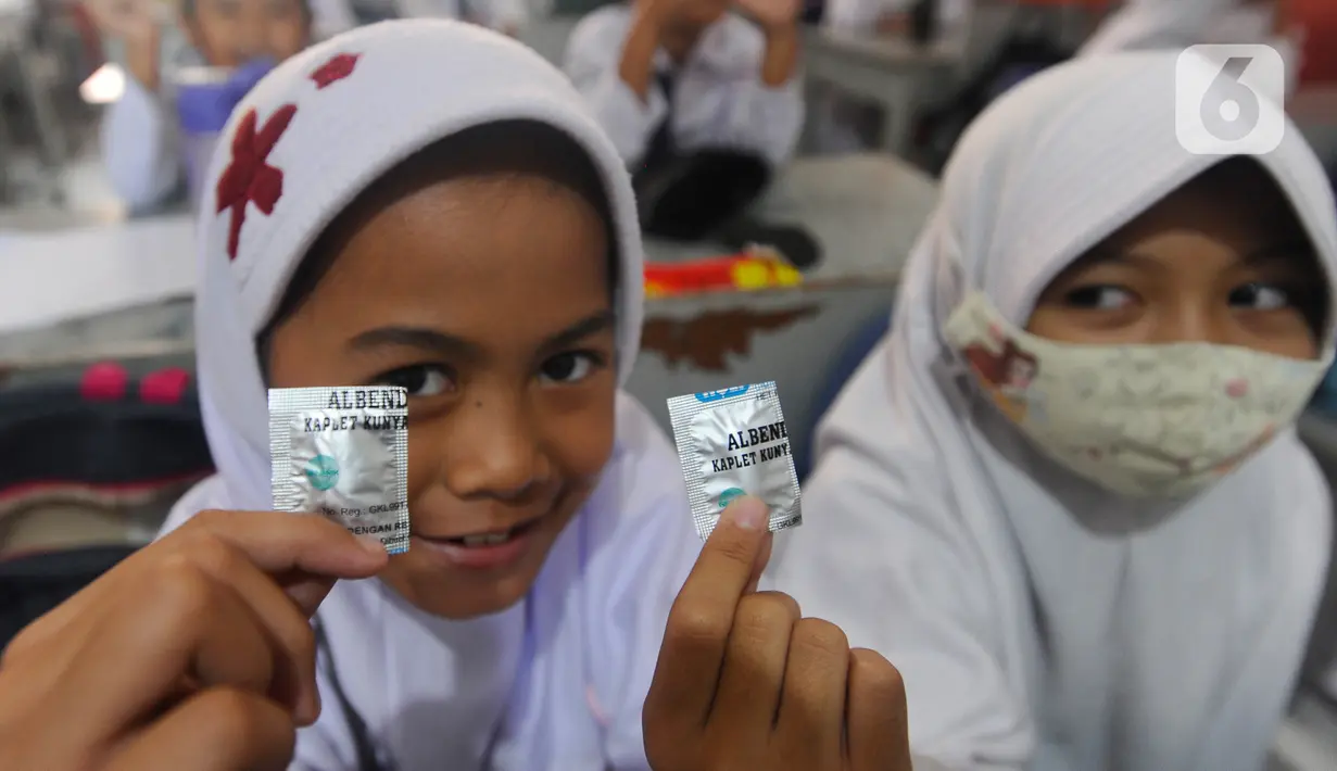 Murid kelas III menunjukkan obat cacing usai diperiksa kesehatan di SDI Al Hidayah, Cinere, depok, Senin (12/9/20222). Selain pemeriksaan gigi, telinga, dan kuku yang dilakukan periodik 6 bulan sekali  juga dilakukan penyuluhan kesehatan dan pemberian obat cacing kepada anak-anak.
(merdeka.com/Arie Basuki)