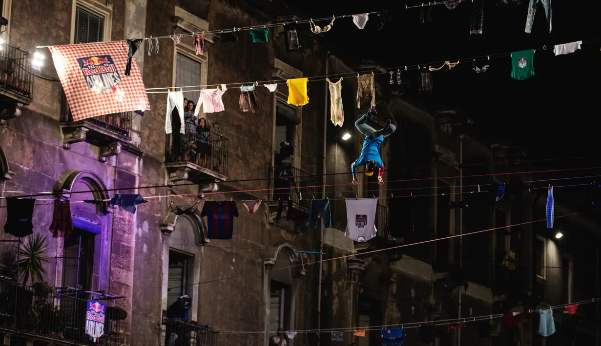 Aksi menegangkan di ketinggian tanpa alat pengaman saat kompetisi slackline Red Bull Airlines di Catania, Italia, Sabtu (8/10) Peserta tampil tanpa alat bantu pengaman di tubuhnya saat beraksi di kompetisi tersebut.(REUTERS)
