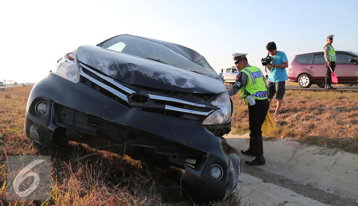 Petugas kepolisian memeriksa kendaraan yang mengalami kecelakaan di Tol Cipali, Jawa Barat, Senin (13/7/2015). Mobil bernomor polisi D 1807 PB tersebut menabrak penanda jalan di Km 149+800. (Liputan6.com/Herman Zakharia)