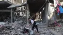 Seorang pria Palestina yang mengungsi memeriksa kerusakan setelah sebuah rumah menjadi sasaran serangan Israel di kamp pengungsi Maghazi, Jalur Gaza Tengah pada Kamis 21 Mei 2026. (Eyad Baba/AFP)