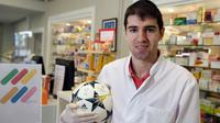 Pemain Royal Navy Thai FC, Toni Dovale, berpose di Apotek Keluarganya di Coruna, Kamis (26/3/2020). Pesepak bola yang bermain di divisi dua Thailand ini sementara waktu berhenti menjadi pesepak bola dan memilih menjadi apoteker. (AFP/Miguel Riopa)