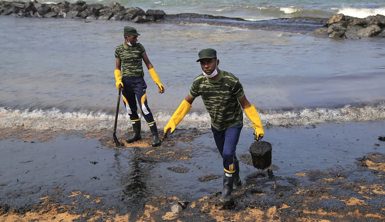 Tentara Sri Lanka membersihkan tumpahan minyak di sebuah pantai di Uswetakeiyawa, Kolombo, Senin (10/9). Sekitar 25 ton minyak tumpah mencemari pantai akibat kebocoran pipa. (AP Photo/Eranga Jayawardena)