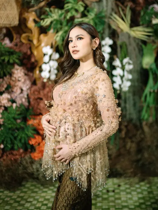 Mahalini Raharja tampil memukau dalam kebaya rancangan desainer ternama, Asky Febrianti. Dengan sentuhan warna soft mocca yang lembut, kebaya ini tidak hanya menampilkan keanggunan tetapi juga dihiasi dengan detail memikat. [@mahalini].