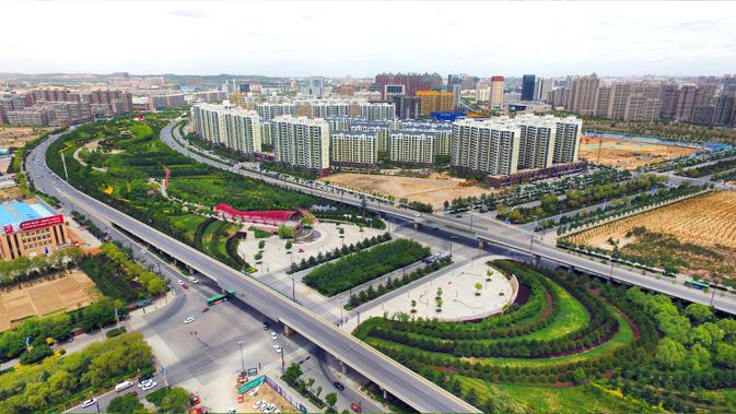 Foto dari udara yang diabadikan pada 25 Mei 2020 ini memperlihatkan sabuk hijau di Kota Yulin, Provinsi Shaanxi, China barat laut. Pada November 2019, kota itu mendapat status Kota Hutan Nasional. (Xinhua/Tao Ming)
