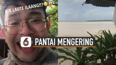 Aneh tapi nyata seorang pria merekam momen berjalan di tengah pantai yang mengering.