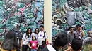 Pengunjung berfoto di kawasan Kebun Binatang Ragunan, Jakarta, Jumat (1/1). Jumlah pengunjung Taman Margasatwa Ragunan pada libur awal tahun 2016 mencapai lebih dari 100.000 orang. (Liputan6.com/Immanuel Antonius)