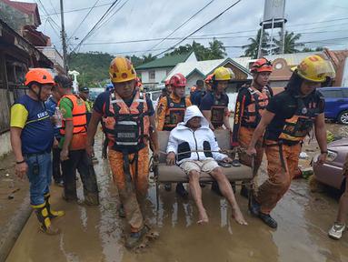 Tim penyelamat mengevakuasi seorang warga dari rumahnya yang terendam banjir menyusul hujan deras yang dibawa oleh Topan Kalmaegi di sebuah permukiman di Kota Cebu, Filipina tengah, pada Selasa 4 November 2025. Topan Kalmaegi menerjang wilayah permukiman warga di Kota Cebu, Filipina tengah pada Selasa 4 November 2025. (Alan TANGCAWAN/AFP)