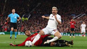 Pemain Galatasaray, Dries Mertens (atas), mendapatkan pelanggaran keras dari pemain MU, Casemiro dalam pertandingan lanjutan Grup A Liga Champions 2023/2024 yang berlangsung di Old Trafford, Manchester, Rabu (4/10/2023) dini hari WIB. Pelanggaran tersebut terjadi akibat kelalaian Andre Onana yang salah mengumpan bola. (AFP/Darren Staples)