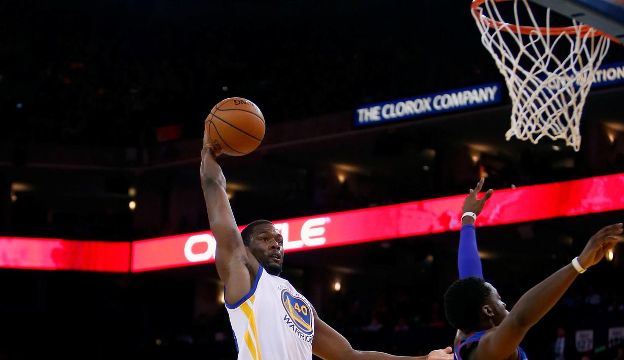 Pebasket Golden State Warriors Harrison Barnes melakukan Dunk saat dibayangi pebasket Detroit Pistons Reggie Jackson di ORACLE Arena, California, Senin (9/11/2015). Warriors menang 109-95. (Getty Images/AFP/Ezra Shaw)