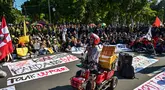 Seorang pedagang penyandang disabilitas menyampaikan pidato saat aksi protes menentang kenaikan harga Bahan Bakar Minyak (BBM) non-subsidi dan program Makan Siang Gratis (MBG) di Surabaya, Jawa Timur, Rabu 17 Juni 2026. (JUNI KRISWANTO/AFP)