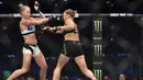 Ronda Rousey, bertukar pukulan dengan Holly Holm, pada pertarungan perebutan gelar juara kelas bantam UFC Women di Stadion Etihad, Melbourne, Minggu (15/11/2015). (AFP Photo/Paul Crock)
