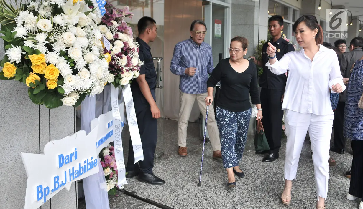 Pelayat melintasi karangan bunga duka cita untuk mendiang Eka Tjipta Widjaja di depan Rumah Duka Sentosa RSPAD Gatot Soebroto, Jakarta, Minggu (27/1). Pendiri Sinar Mas Group tersebut meninggal dunia pada 26 Januari 2019. (Merdeka.com/Iqbal Nugroho)