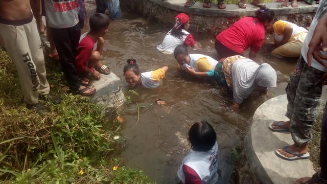 Salah satu kegiatan ngagogo ikan (menangkap ikan) di sungai dalam kegiatan deklarasi dukungan pemenangan Rekan Desa bagi Jokowi-Maruf Amin di Garut