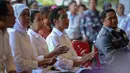 Jokowi (kedua kanan) didampingi Menteri BUMN Rini Soemarno (ketiga kiri) dan Mensos Khofifah Indar Parawansa (kedua kiri) saat membagikan 3.289 KIS kepada buruh PT Dok & Perkapalan Kodja Bahari, Jakarta, Selasa (28/4/2015). (Liputan6.com/Faizal Fanani)