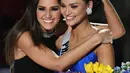 Miss Universe 2014, Paulina Vega memeluk Miss Universe 2015, Pia Alonzo Wurtzbach setelah mahkota dipasang. Senyum manis menghiasi kedua wajah wanita cantik ini. (AFP/Bintang.com)