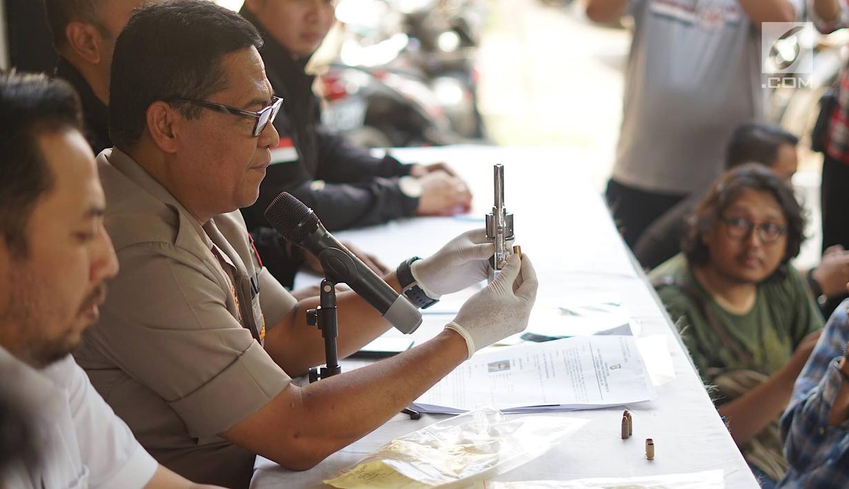 Kabid Humas Polda Metro Jaya Kombes Argo Yuwono menunjukkan senjata api rakitan di Polda Metro Jaya, Jakarta, Kamis (4/7/2019). Polisi berhasil mengamankan barang bukti berupa satu buah sepeda motor, satu pucuk senjata api rakitan, dan tiga butir amunisi. (Liputan6.com/Immanuel Antonius)