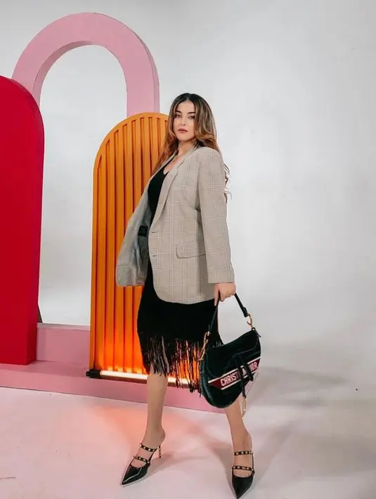 Kerap bereksplorasi dalam mengenakan fashion item, kali ini ia memilih dress dengan aksen rumbai disertai blazer yang menjadikan tampilannya semakin variatif.(Instagram/tasyafarasya).