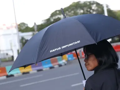 Aktivis melaksanakan aksi kamisan perdana di tahun 2019 di depan Istana Negara, Jakarta, Kamis (3/1). Mereka meminta pemerintah menuntaskan penyelesaian kasus pelanggaran HAM masa lalu. (Liputan6.com/Helmi Fithriansyah)