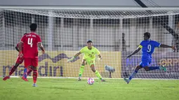 Kiper Timnas Indonesia, Ikram Al Giffari (tengah) bersiap menerima tendangan pemain Maladewa, Shanaan Rashaad (kanan) pada laga Grup F Kualifikasi Piala Asia U-20 2024 di Stadion Madya, Senayan, Jakarta, Rabu (25/09/2024). (Bola.com/Bagaskara Lazuardi)