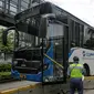 Petugas memeriksa kondisi bus Transjakarta yang menabrak separator busway di kawasan Bundaran Senayan, Jakarta, Jumat (3/12/2021). Kecelakaan mengakibatkan bagian depan bus Transjakarta rusak karena menghantam separator busway. (Liputan6.com/Faizal Fanani)