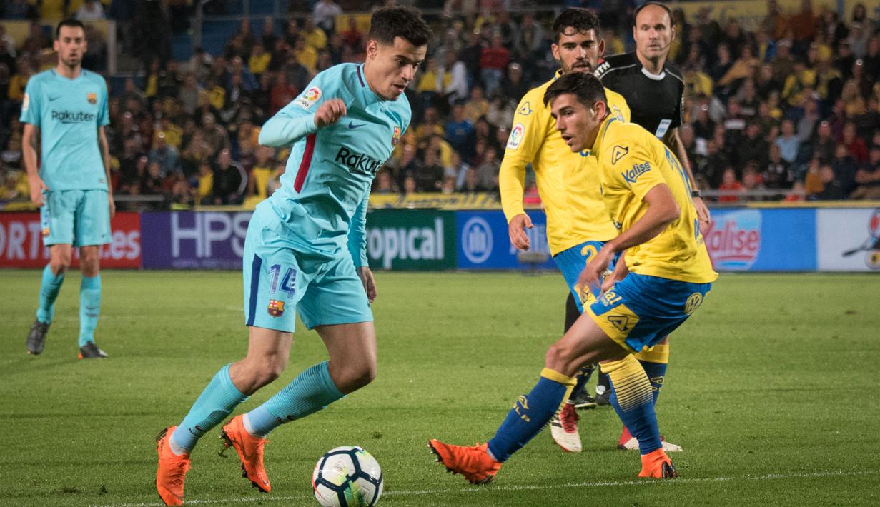 Gelandang Barcelona, Philippe Coutinho, berusaha melewati bek Las Palmas, Ximo Navarro, pada laga La Liga Spanyol di Stadion Gran Canaria, Las Palmas, Kamis (1/3/2018). Kedua klub bermain imbang 1-1. (AFP/Desiree Martin)