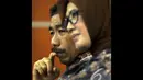 Ekspresi Romi Herton dan Istrinya Masyitoh saat menjalani sidang lanjutan di Pengadilan Tipikor, Jakarta, Kamis (4/12/2014). (Liputan6.com/Miftahul Hayat)