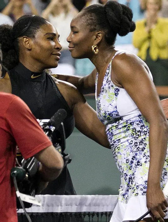 Venus Williams (kanan) memeluk Serena Williams usai memenangkan pertandingan dalam turnamen tenis BNP Paribas Open Open di Indian Wells Tennis Garden, California (12/3). Venus Williams menang 6-3, 6-4 atas Serena Williams. (AP Photo / Crystal Chatham)