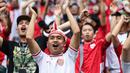 Para suporter Timnas Indonesia memberikan dukungan kepada timnya dalam laga terakhir Grup C Putaran Ketiga Kualifikasi Piala Dunia 2026 melawan Jepang di Suita Stadium, Jepang, Selasa (10/06/2025). (AFP/Paul Miller)