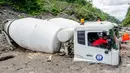 Truk semen milik penambang pasir tertimbun abu vulkanik setelah hujan deras mengguyur lereng Gunung Merapi di Magelang, 2 Desember 2021. Proses evakuasi kendaraan tak bisa segera dilakukan karena sulitnya medan. (AGUNG SUPRIYANTO/AFP)