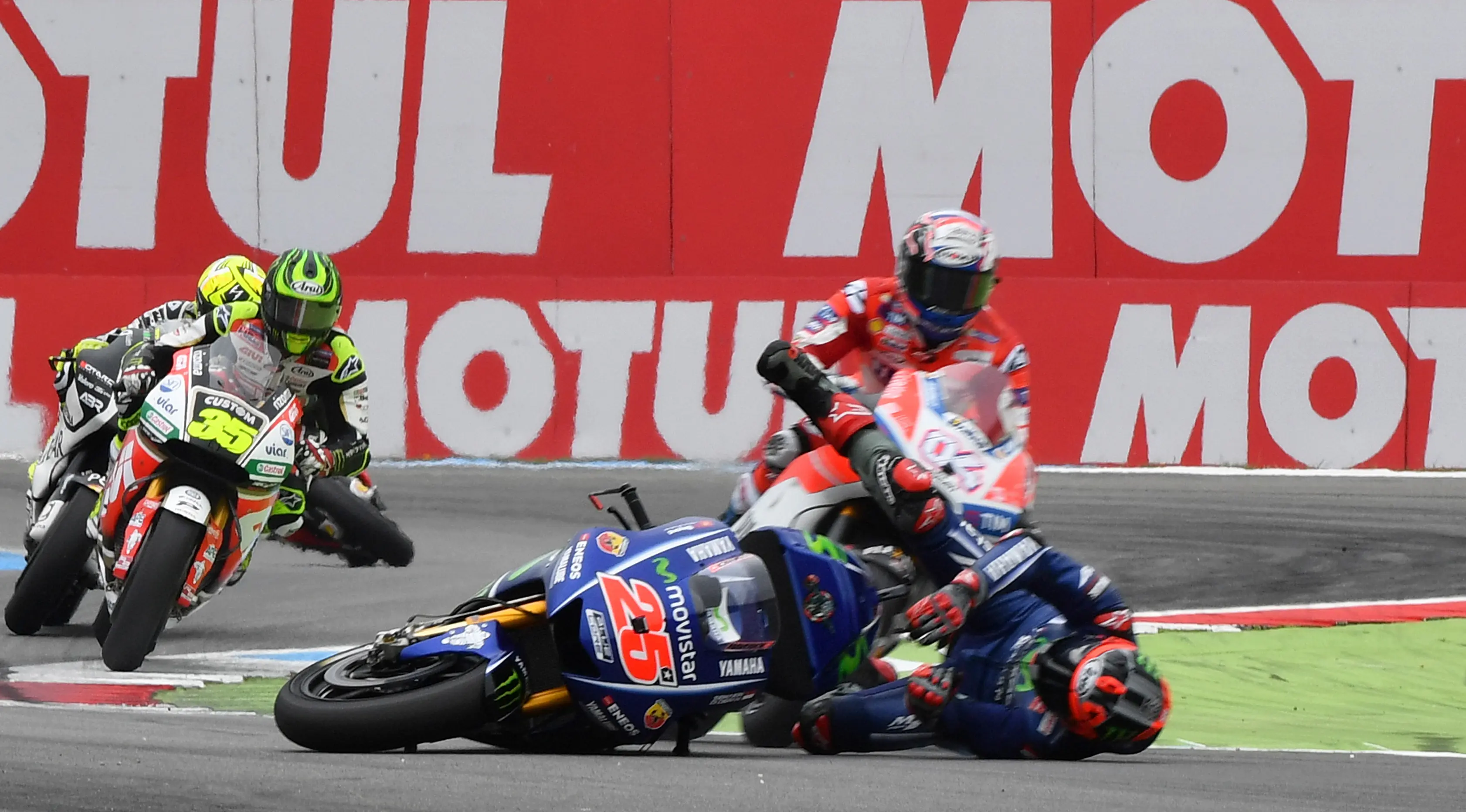 Pembalap Yamaha Movistar, Maverick Vinales terjatuh di chicane terakhir pada putaran ke-11 di Sirkuit Assen MotoGP Belanda, Minggu (25/6). Sebelum terjatuh, Vinales baru saja menyalip pembalap Ducati, Andrea Dovizioso. (AP/Geert Vanden Wijngaert)